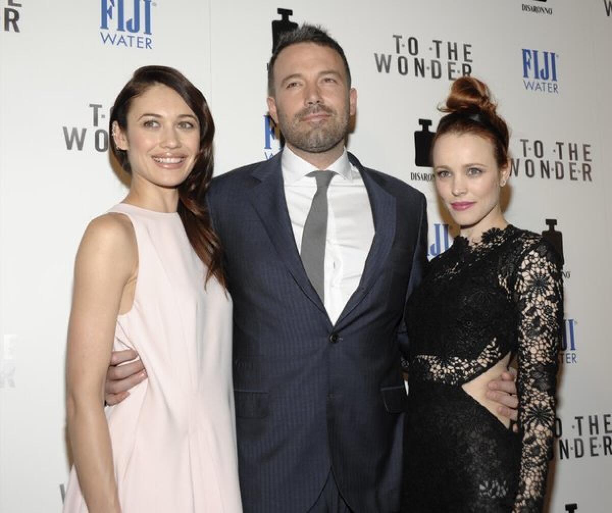 Olga Kurylenko, left, Ben Affleck, and Rachel McAdams arrive at the premiere of "To the Wonder."