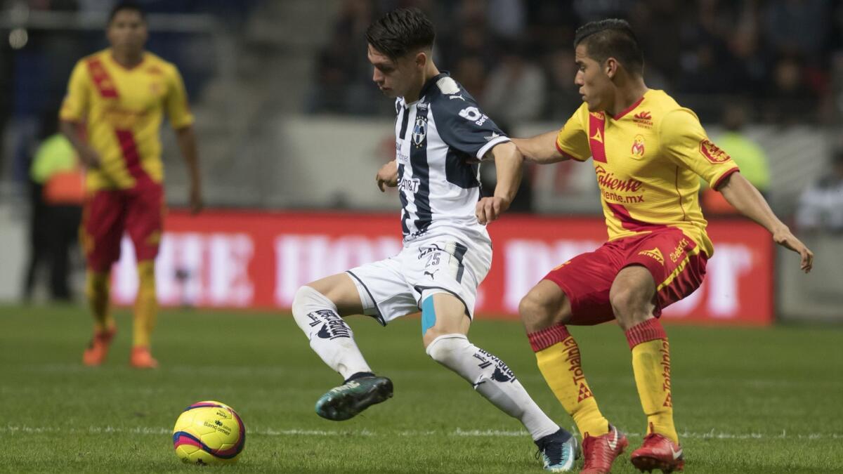 Monterrey's Jonathan Gonzalez, left, vies for the ball with Monarcas Morelia's Aldo Rocha on Saturday.