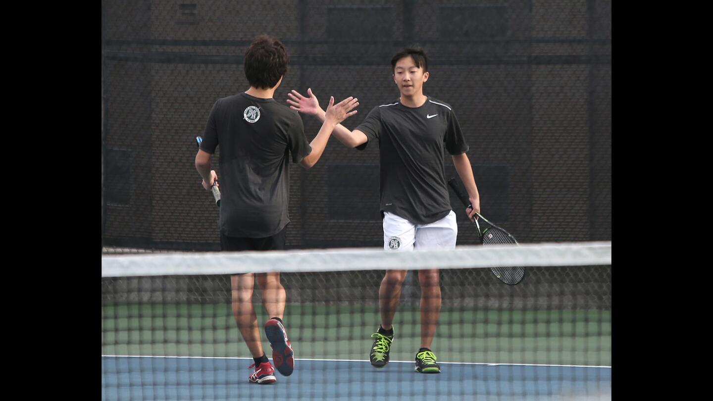 Sage Hill's Ian Huang and Jerry Fu high five a point during nonleague match against Santa Margarita on Wednesday.