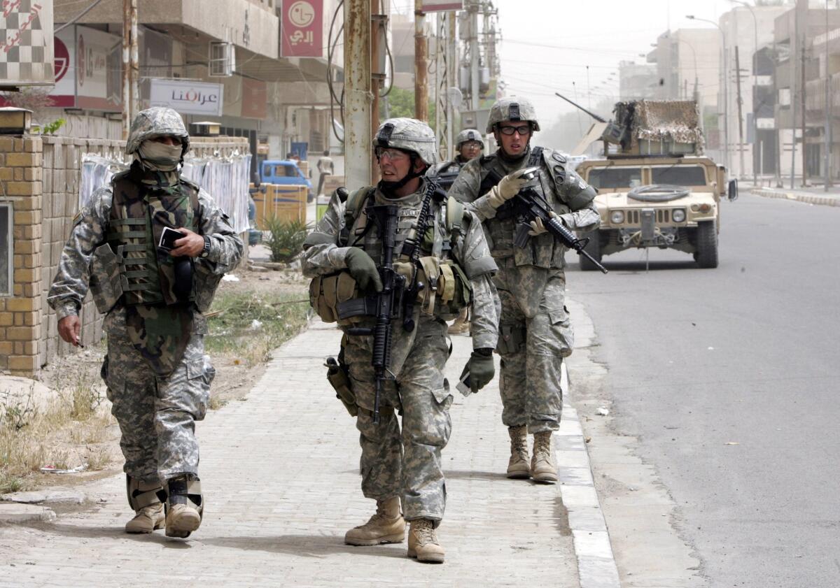 A photograph from 2007 shows U.S. troops patrolling a street in Baghdad. On Sunday, the U.S. Embassy said "several" U.S. citizens had gone missing in the Iraqi capital. Local media reported they had been abducted by militias.