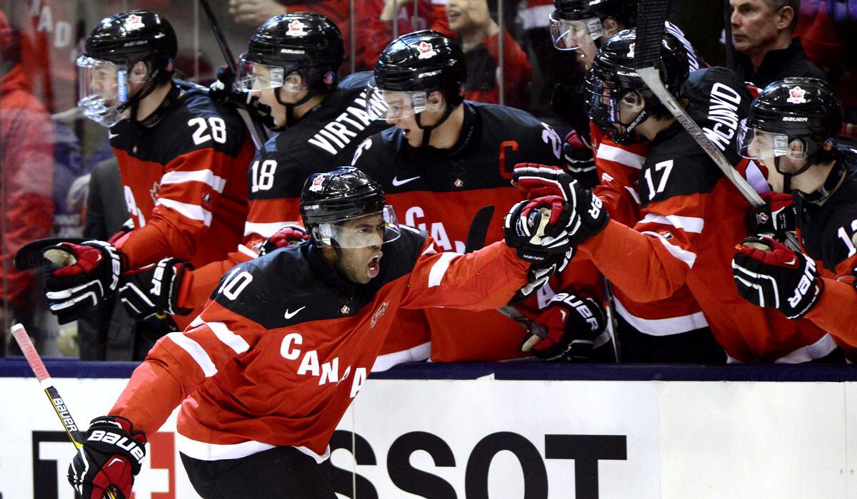 Canada's Anthony Duclair celebrates his first-period goal against Russia with teammates on the bench during the world junior hockey championship game on Monday night.