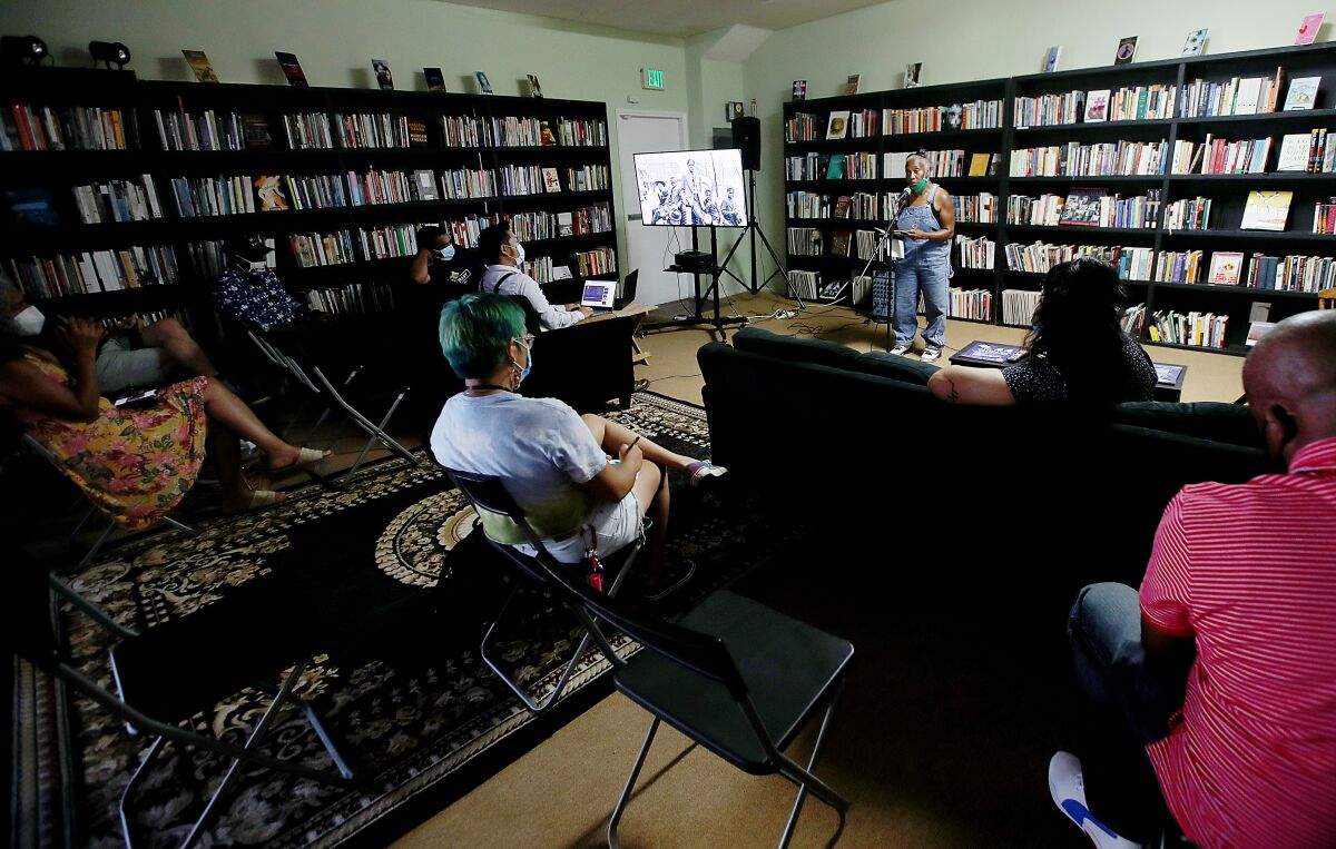 Poets participate in a community reading at the Sims Library of Poetry in South L.A.