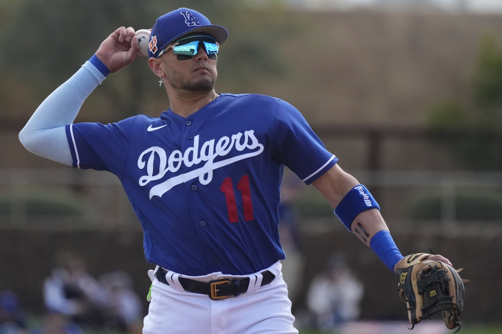 Dodgers shortstop Miguel Rojas warms up during the second inning of a spring training baseball game 