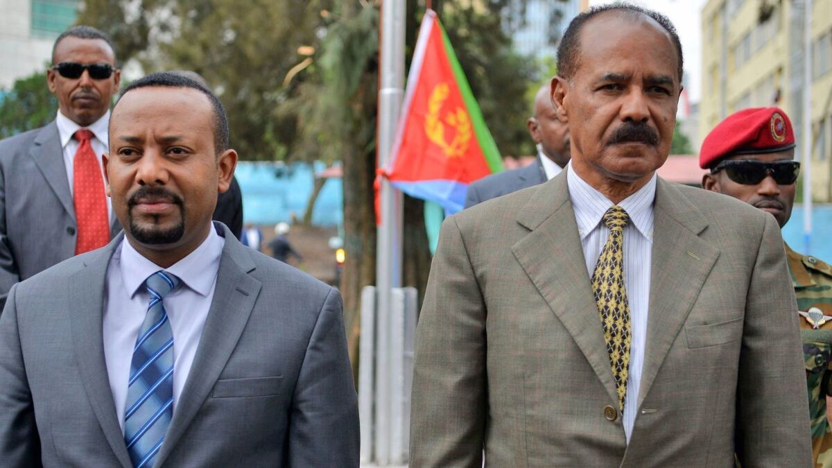 Ethiopia's Prime Minister Abiy Ahmed, left, and Eritrea's President Isaias Afwerki attend the reopening of the Eritrean embassy in Ethiopia on July 16. The two leaders opened the border between their countries on Tuesday.