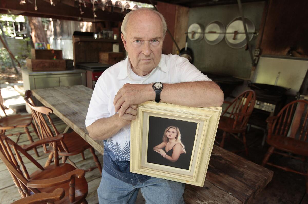 Mike Reynolds with a framed photo of his slain daughter