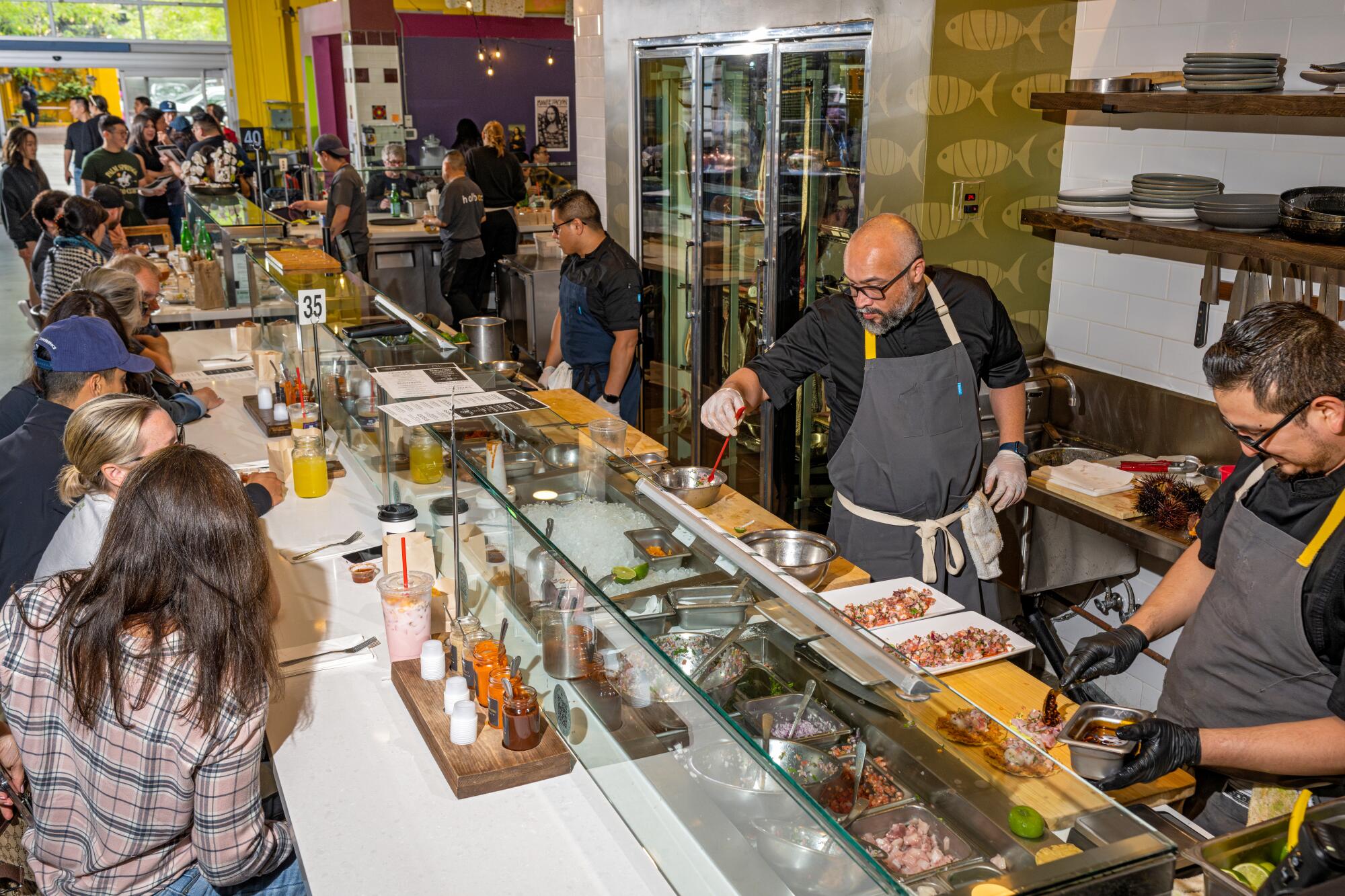 Chef Gilberto Cetina and team prepping ceviche and other seafood dishes during a recent weekend lunch rush at Holbox. 