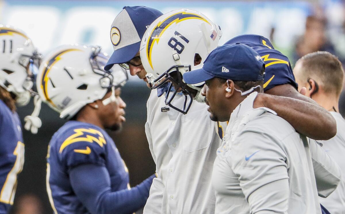 Chargers wide receiver Mike Williams (81) is helped off the field after injuring his ankle against the Seattle Seahawks.