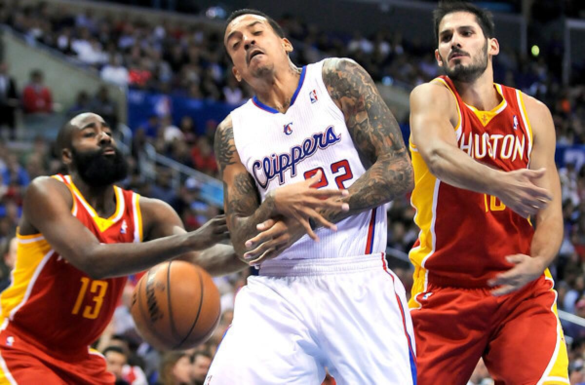 Clippers forward Matt Barnes, who will not play Saturday night, has the ball stripped away by Rockets guard James Harden (13) during a game earlier this week at Staples Center. Harden will be a game-time decision because of foot problems.