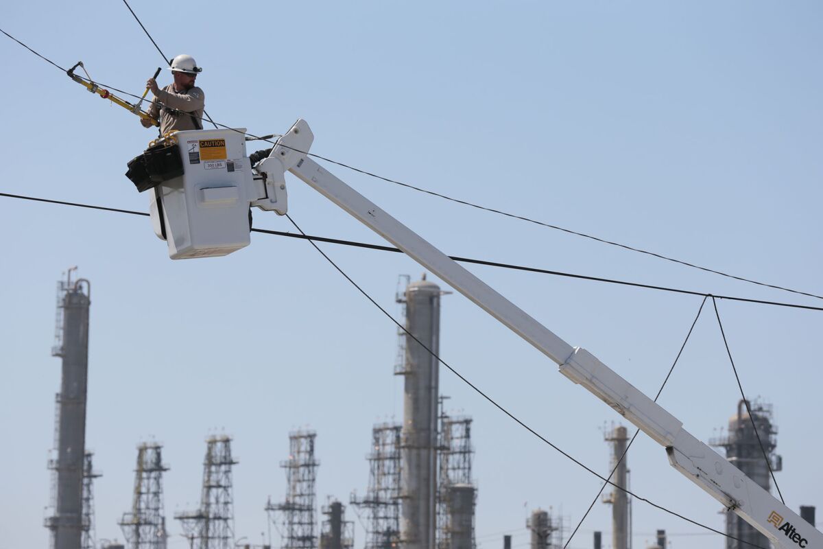 A Southern California Edison worker fixes a severed power line in Torrance.