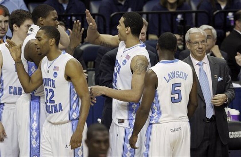 North Carolina coach Roy Williams, right, and his team celebrate after beating Oklahoma 72-60 in the men's NCAA tournament South Regional championship college basketball game in Memphis, Tenn., Sunday, March 29, 2009. From left are Bobby Frasor, Deon Thompson, Wayne Ellington (22), Danny Green (14), Ty Lawson (5) and Williams. (AP Photo/Matt Slocum)