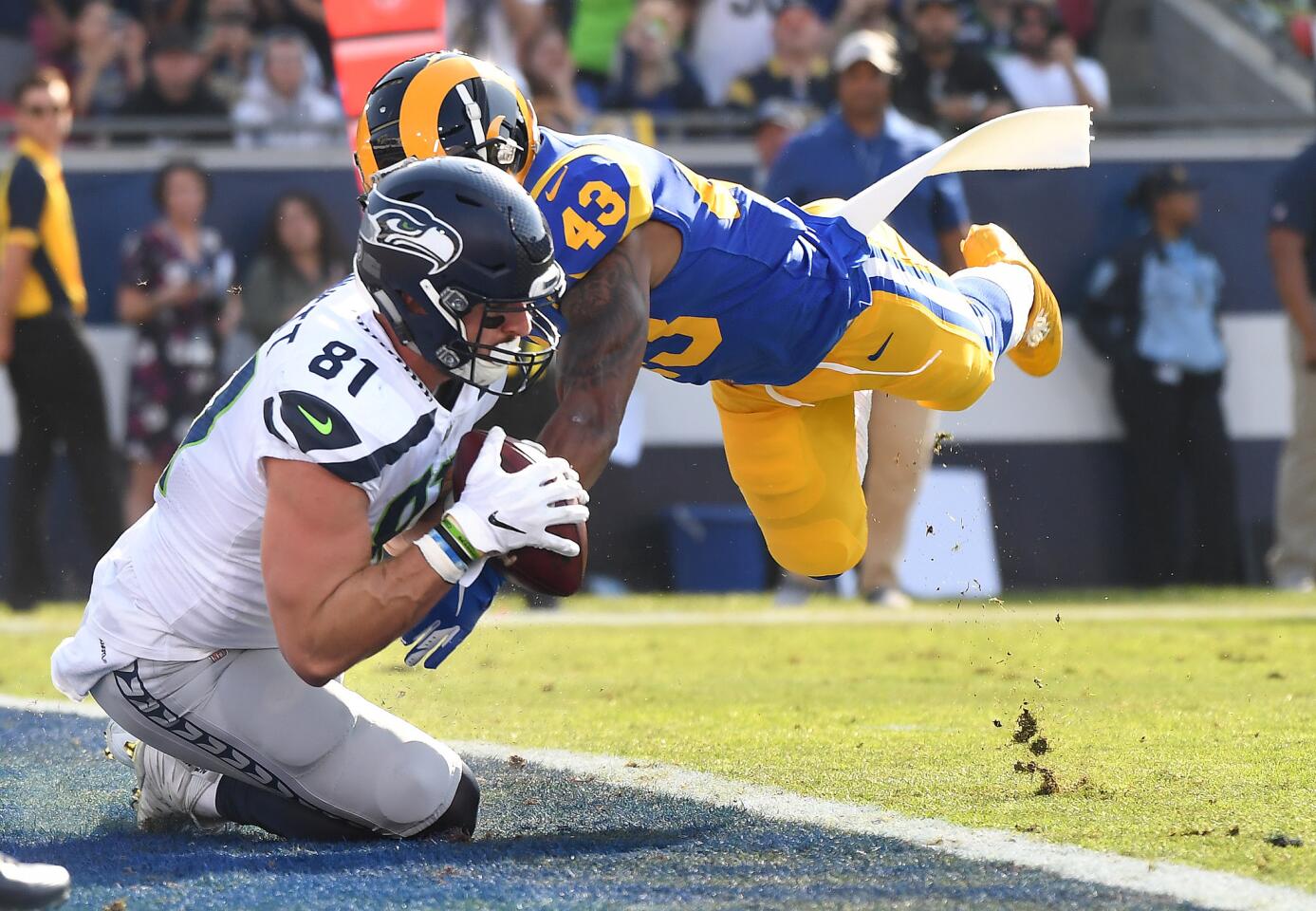Seattle Seahawks tight end Nick Vannett catches a touchdown pass in front of Rams safety John Johnson in the first quarter at the Coliseum on Sunday.