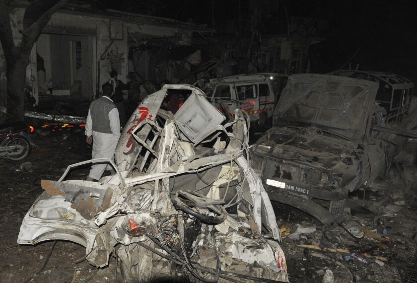 Destroyed vehicles remain at the site of a bomb attack in the Pakistani city of Quetta.