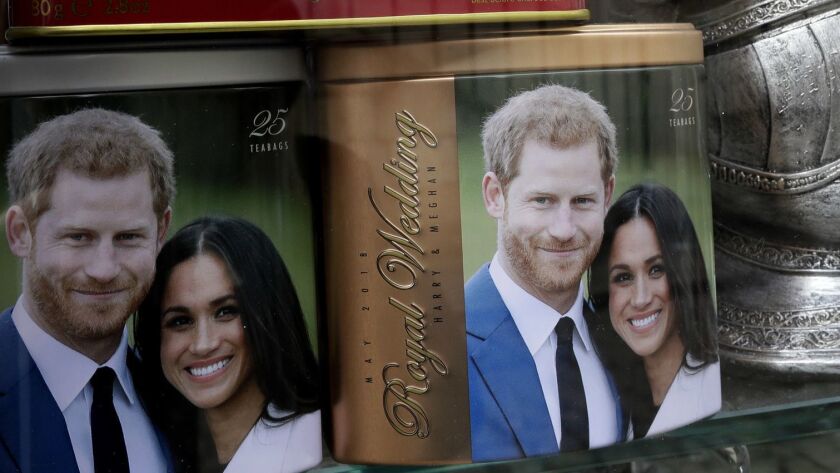 Memorabilia with a photograph the image of Britain's Prince Harry and Meghan Markle are displayed for sale in a shop window in Windsor, England, Thursday, March 29, 2018. Britain's Prince Harry will marry Meghan Markle in Windsor on May 19. (AP Photo/Kirsty Wigglesworth)