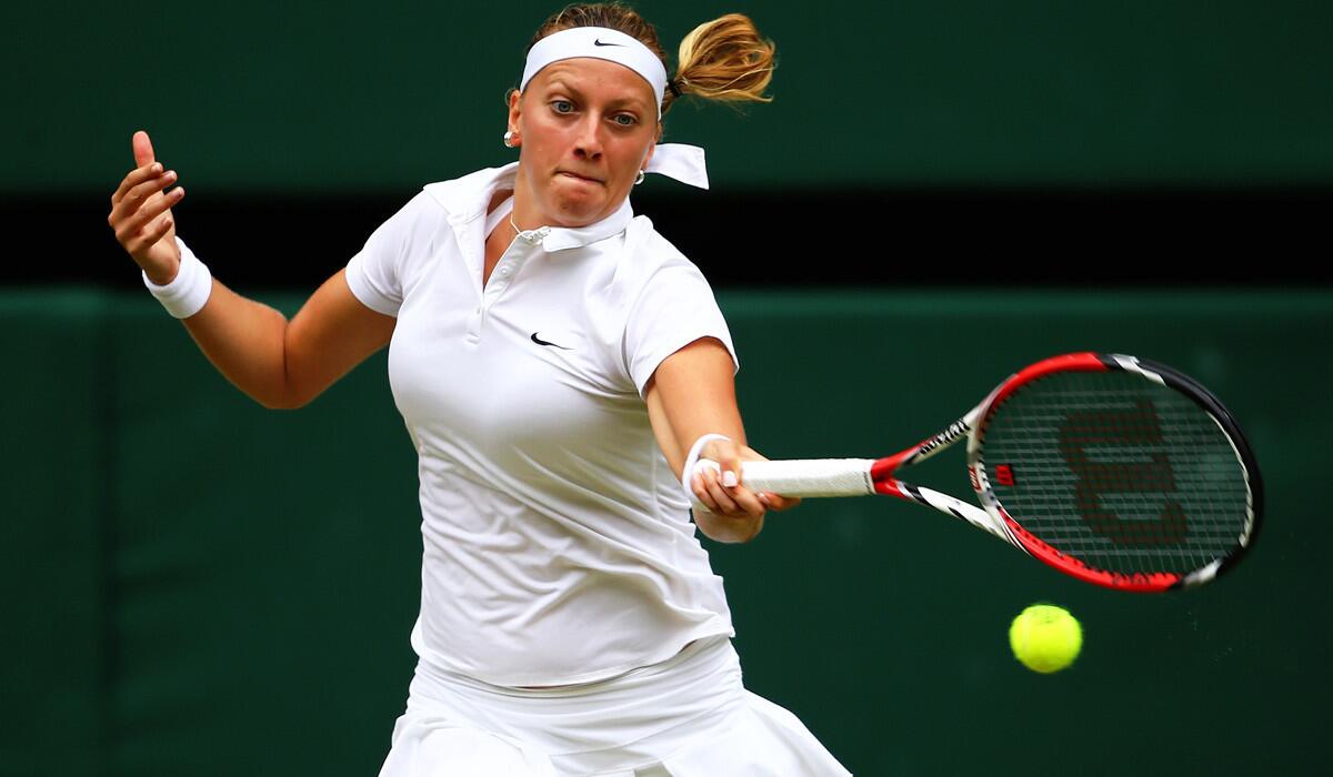 Two-time champion Petra Kvitova returns a shot against Eugenie Bouchard during the Wimbledon women's final on Saturday.