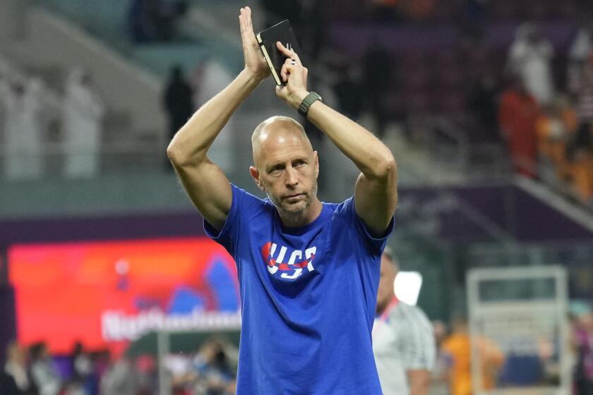 head coach Gregg Berhalter of the United States salutes supporters at the end of the World Cup.