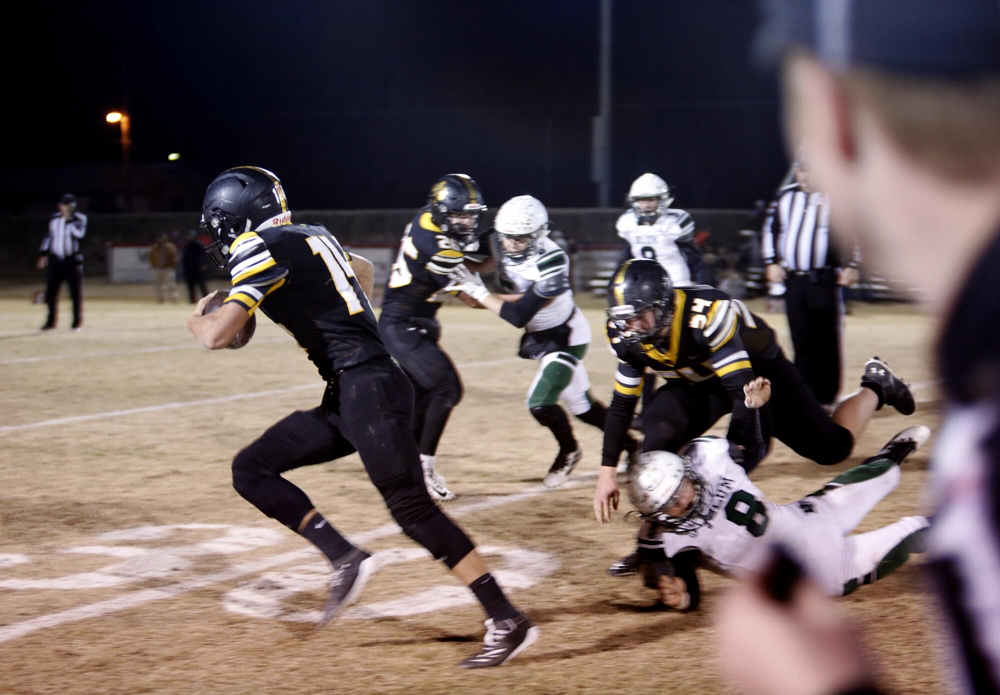 Jonesboro (black) goes head to head with Blum during the semifinals of Texas six-man 1A football where Blum and Jonesboro fight for a spot in the state championships in Hico, Texas.