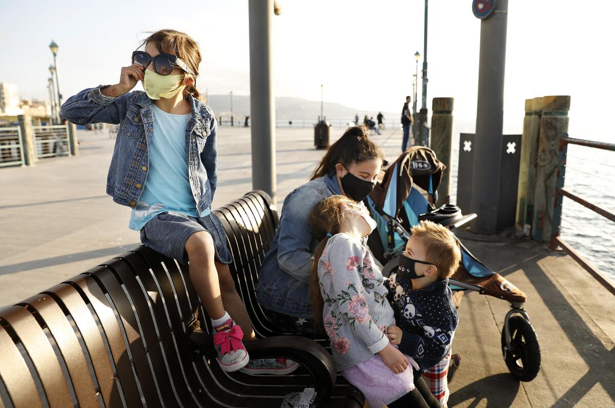 Juliet Brown, 5, left, visits the Redondo Beach Pier with her siblings Evelyn, 7, and Joshua, 2, center, and their nanny