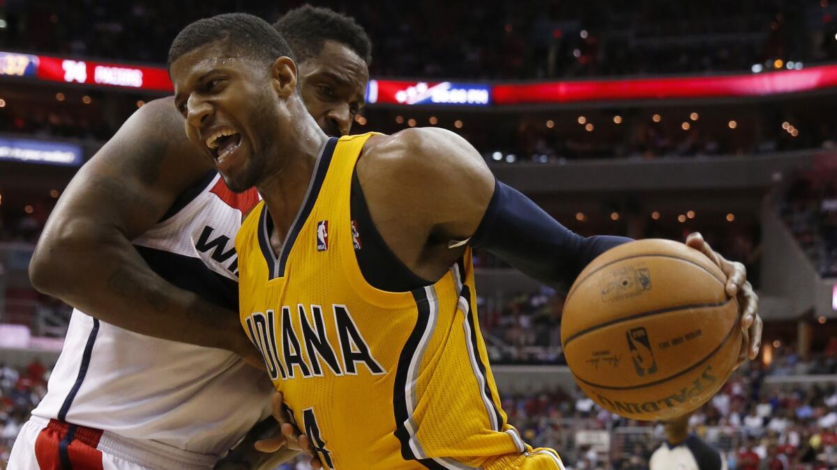 Indiana Pacers forward Paul George, right, drives past Washington Wizards forward Martell Webster during the Pacers' win in Game 4 of the Eastern Conference semifinals Sunday.