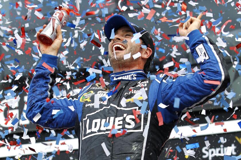 FILE - Jimmie Johnson celebrates after winning the Daytona 500 NASCAR Sprint Cup Series auto race, Sunday, Feb. 24, 2013, at Daytona International Speedway in Daytona Beach, Fla. Jimmie Johnson and Chad Knaus will be feted together in Friday night’s NASCAR Hall of Fame ceremonies. (AP Photo/Terry Renna, File)