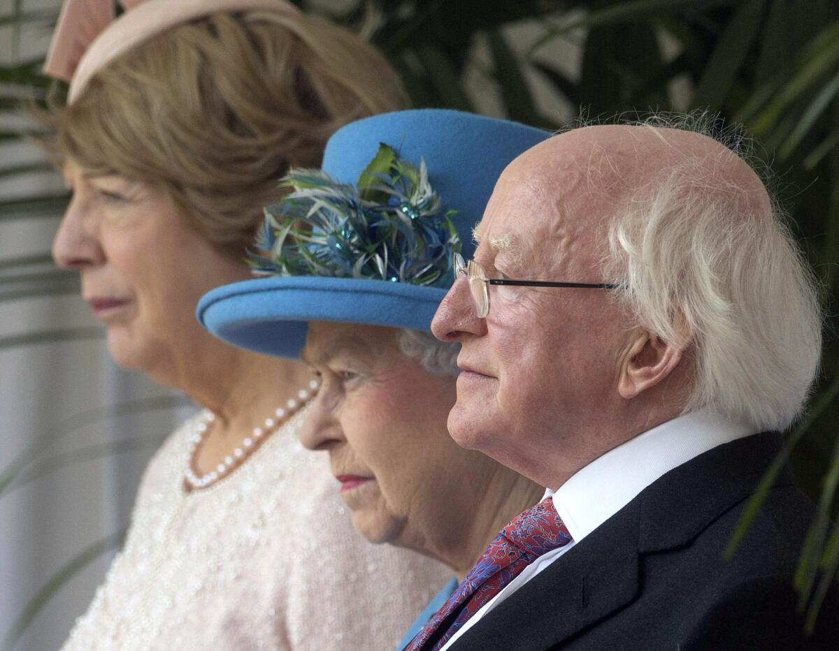Britain's Queen Elizabeth II is flanked by Irish President Michael D. Higgins and his wife, Sabina, during an official welcoming ceremony for Higgins at Windsor Castle.