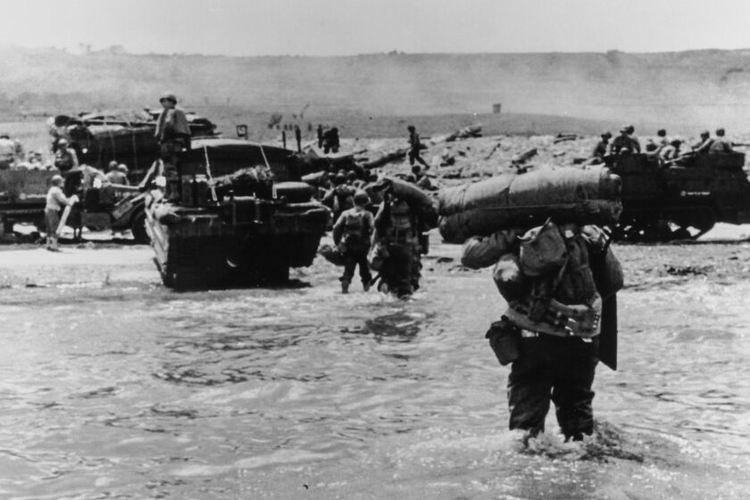  American assault troops with full equipment move onto Omaha Beach, Normandy June 6, 1944 