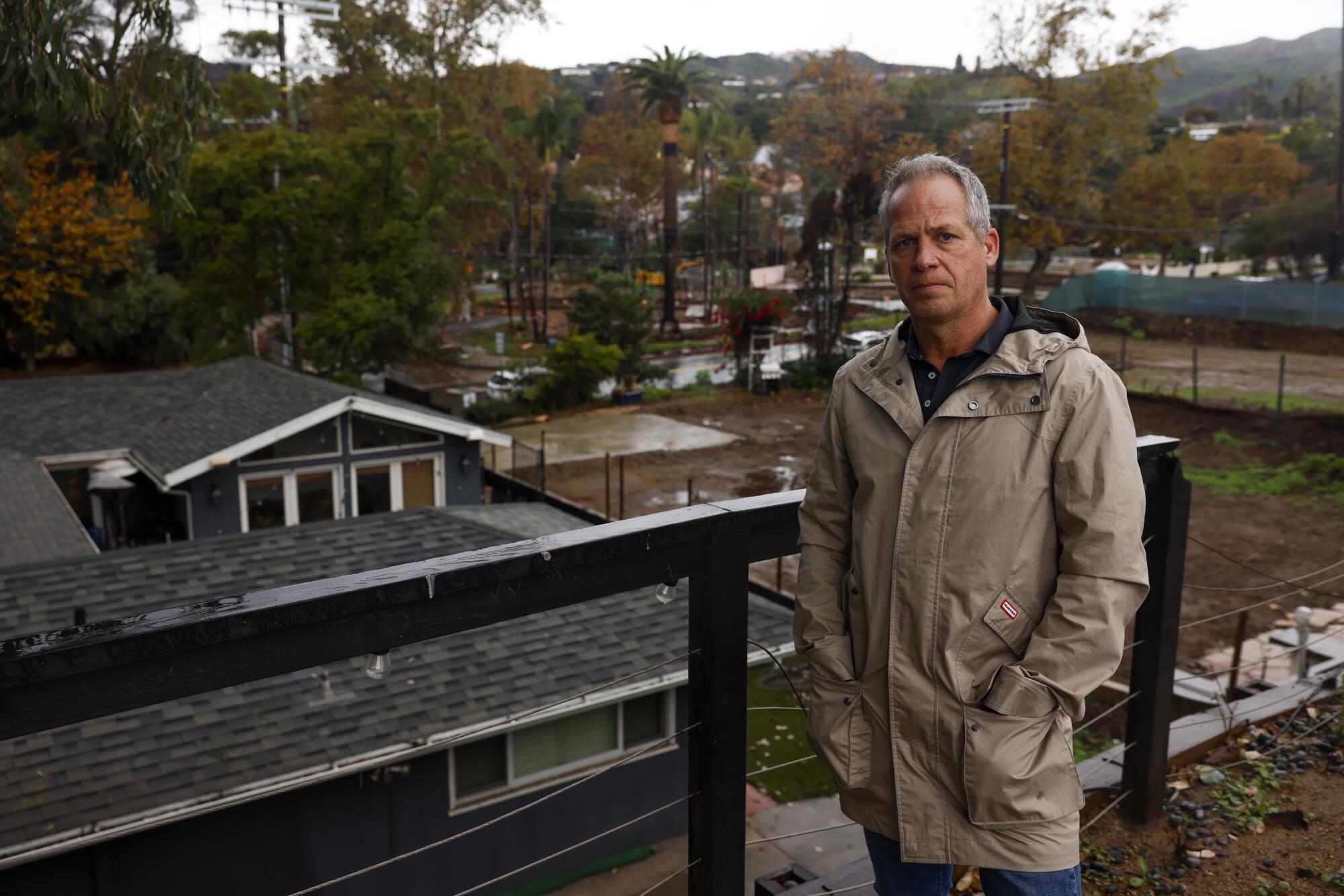 George Engel stands next to his Pacific Palisades home, which was damaged but remained standing after the Palisades fire.