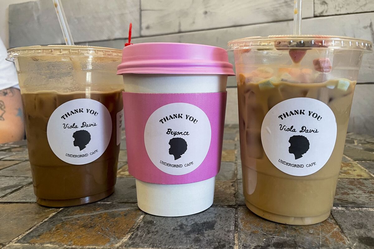 Three coffee drinks with labels featuring a silhouetted head