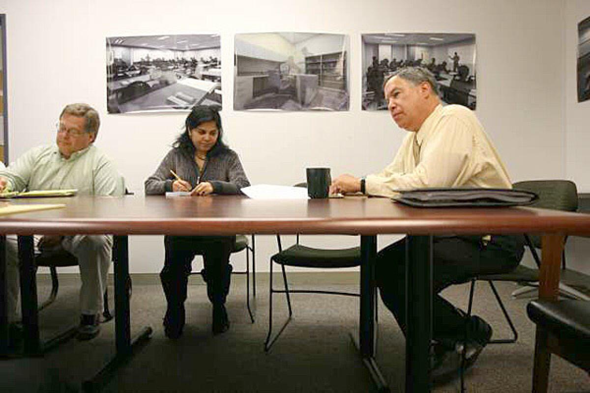 Larry Eisenberg, head of the construction program, right, at a meeting. In an April 2009 e-mail, he told his construction chief that quality control was "horrible," adding: "We are opening buildings that do not work at the most fundamental level."