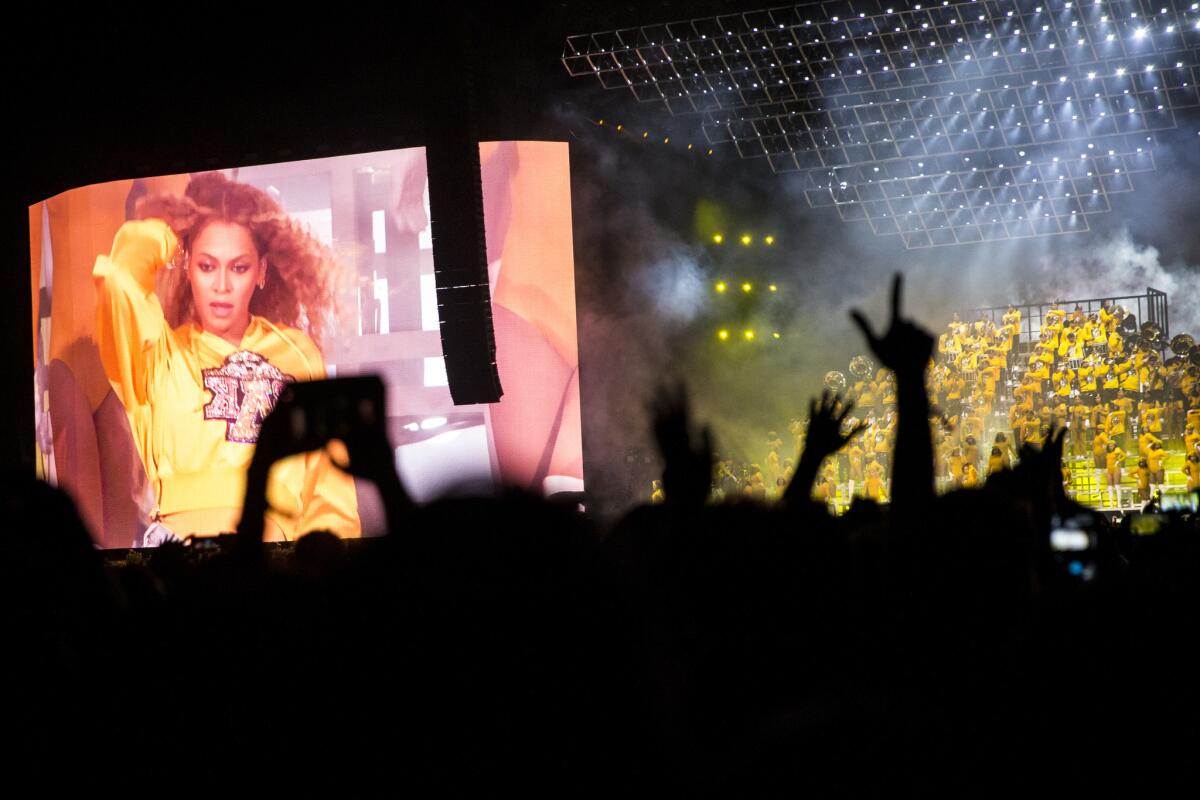 The view of Beychella from the crowd: Fans capture Beyonce Knowles' performance Saturday at the Coachella Valley Music and Arts Festival.