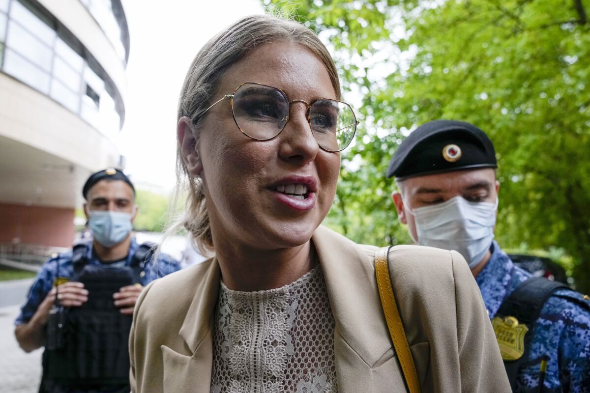 FILE - Russian opposition activist Lyubov Sobol, a close ally of Alexei Navalny, looks at photographers as she arrives at the court in Moscow, Russia, Tuesday, Aug. 3, 2021. A Moscow court replaced the parole-like restrictions on Sobol with a prison sentence of nearly six months on Thursday, April 14, 2022. (AP Photo/Alexander Zemlianichenko, File)