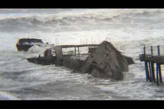 The broken hull of the Palo Alto in the waves