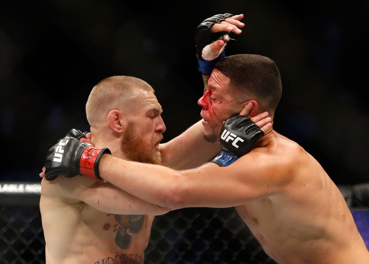 Conor McGregor, left, and Nate Diaz grapple during their welterweight rematch at UFC 202.