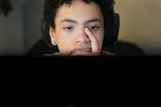 Miles Fallon works at his computer in his Chicago home Wednesday, Oct. 12, 2022. His mother, Marla Williams, initially supported the Chicago Public Schools decision to instruct students online during the fall of 2020. Williams, a single mother, has asthma, as do her two children. While she was working, she enlisted her father, a retired teacher, to supervise her children’s studies. (AP Photo/Charles Rex Arbogast)