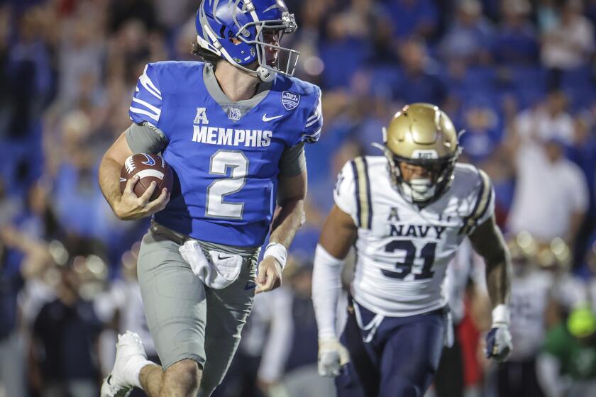 Memphis quarterback Seth Henigan (2) runs into the end zone for a touchdown against Navy during an NCAA college football game Thursday, Sept. 14, 2023, in Memphis, Tenn. (Patrick Lantrip/Daily Memphian via AP)