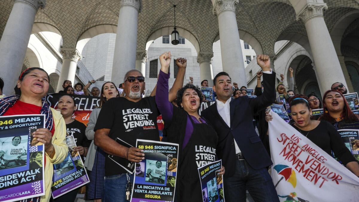 Sidewalk vendors, members of the Los Angeles Vendor Campaign and their backers rally at L.A. City Hall in support of the Safe Sidewalk Vending Act.