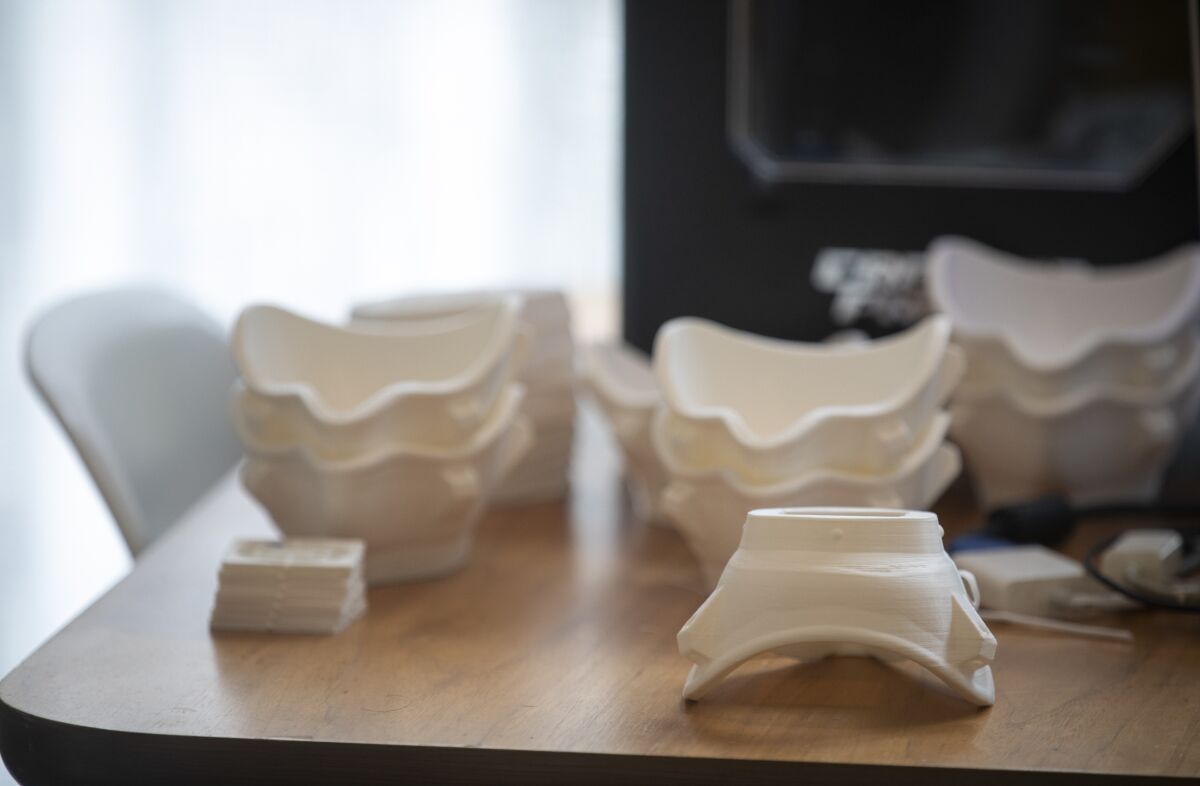 Architects use a digital file to 3-D-print plastic shells later fitted with HEPA filters, weather-stripping sealant and elastic or string ties. 