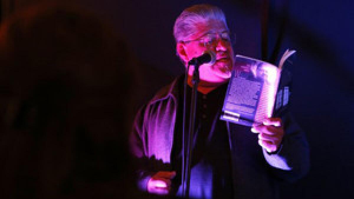 BELL, CA, FRIDAY, MARCH 28, 2014 -- Poet, author, activist Luis Rodriguez reads a poem from his book "Poems Across the Pavement," at "Alivio," an open mic night in the garage of Eric Contreras. (Robert Gauthier/Los Angeles Times)