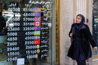 TEHRAN, IRAN - FEBRUARY 22: People follow currency rate from a screen at exchange office after dollar and euro reaches the highest levels in the country's history on February 22, 2023 in Tehran, Iran. The selling rate of the dollar was 45 thousand 200 Iranian toman, while the euro was traded at 48 thousand 200 Iranian toman in the country. (Photo by Fatemeh Bahrami/Anadolu Agency via Getty Images)