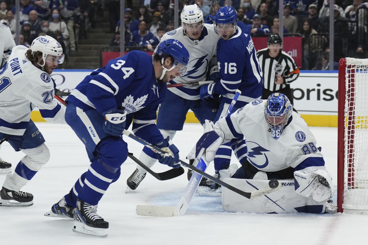 Tampa Bay Lightning goaltender Andrei Vasilevskiy (88) makes a save on Toronto Maple Leafs center Auston Matthews (34) during the second period of Game 5 of an NHL hockey Stanley Cup first-round playoff series, Tuesday, May 10, 2022 in Toronto. (Nathan Denette/The Canadian Press via AP)