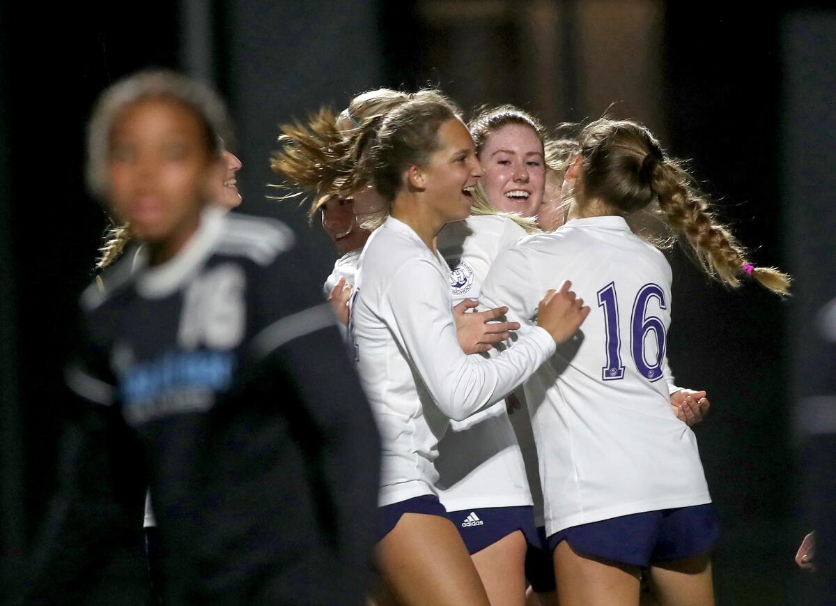 Newport Harbor celebrates a goal against Corona del Mar in the Battle of the Bay girls' soccer match on Thursday.