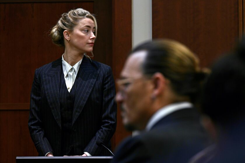 Actors Amber Heard and Johnny Depp, watch the jury arrive in the courtroom at the Fairfax County Circuit Courthouse in Fairfax, Va., Tuesday, May 17, 2022. Depp sued his ex-wife Amber Heard for libel in Fairfax County Circuit Court after she wrote an op-ed piece in The Washington Post in 2018 referring to herself as a "public figure representing domestic abuse." (Brendan Smialowski/Pool photo via AP)