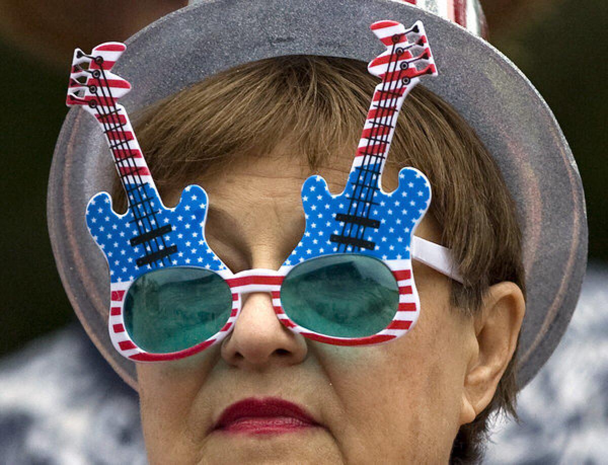 A woman wearing guitar-styled sunglasses attends the Myrtle Beach Tea Party protest at the Internal Revenue Service office.