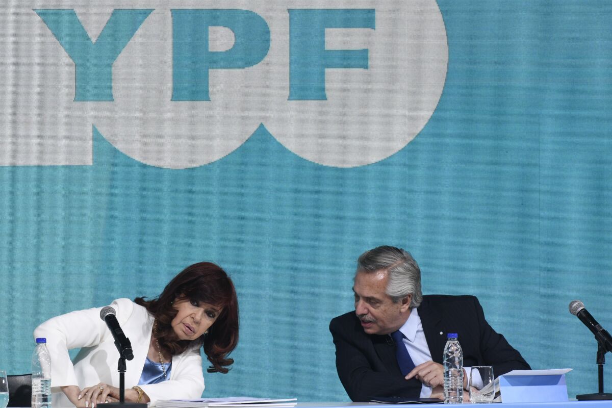 FILE - Argentina's President Alberto Fernandez, right, and Vice President Cristina Fernandez, attend a ceremony celebrating the 100th anniversary of the state-run oil company YPF, in Buenos Aires, Argentina, Friday, June 3, 2022. The abrupt resignation of Argentina’s economy minister over the weekend first week of July 2022, engulfed the country in an all-too familiar feeling of crisis and amounted to yet another sign of isolation for President Alberto Fernández who appears to be quickly losing allies in the governing coalition while Vice President Cristina Fernández de Kirchner gains ground. (AP Photo/Gustavo Garello, File)