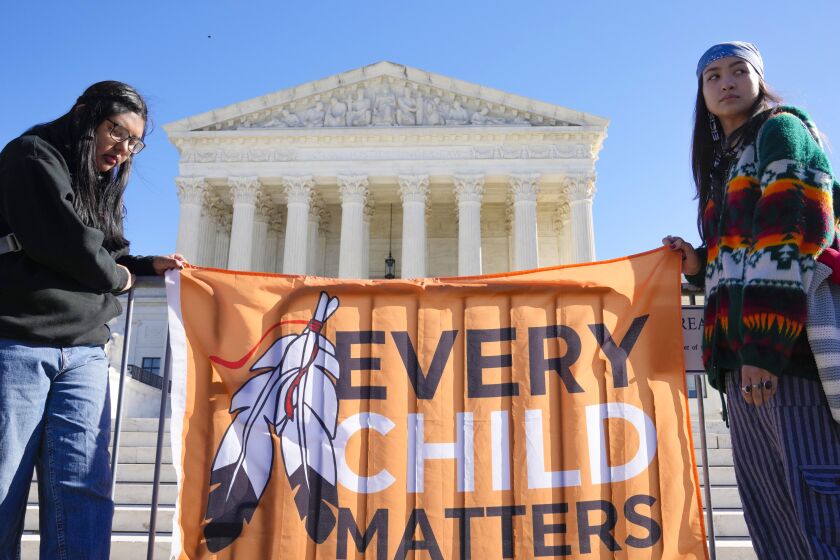 FILE - Demonstrators stand outside of the U.S. Supreme Court, as the court hears arguments over the Indian Child Welfare Act on Nov. 9, 2022, in Washington. Montana is one of a handful U.S. states considering legislation this year to include provisions of the Indian Child Welfare Act in state law. (AP Photo/Mariam Zuhaib, File)
