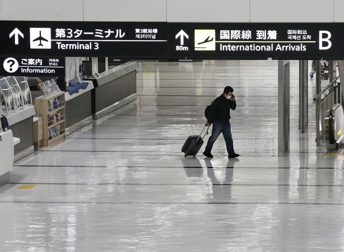 A nearly deserted lobby for international arrivals at a Tokyo airport