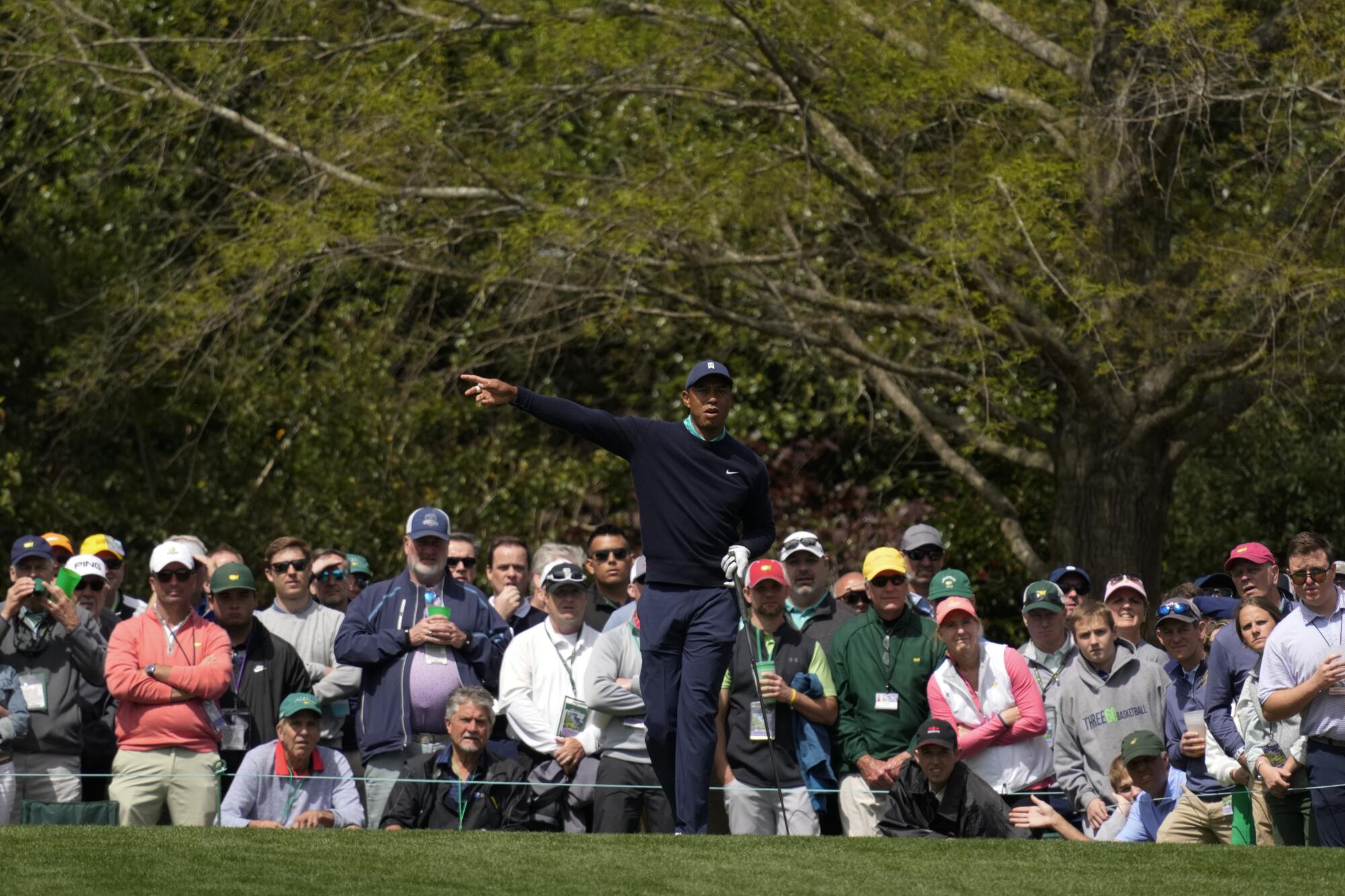 Tiger Woods calls his shot after teeing off on the fifth hole during the second round