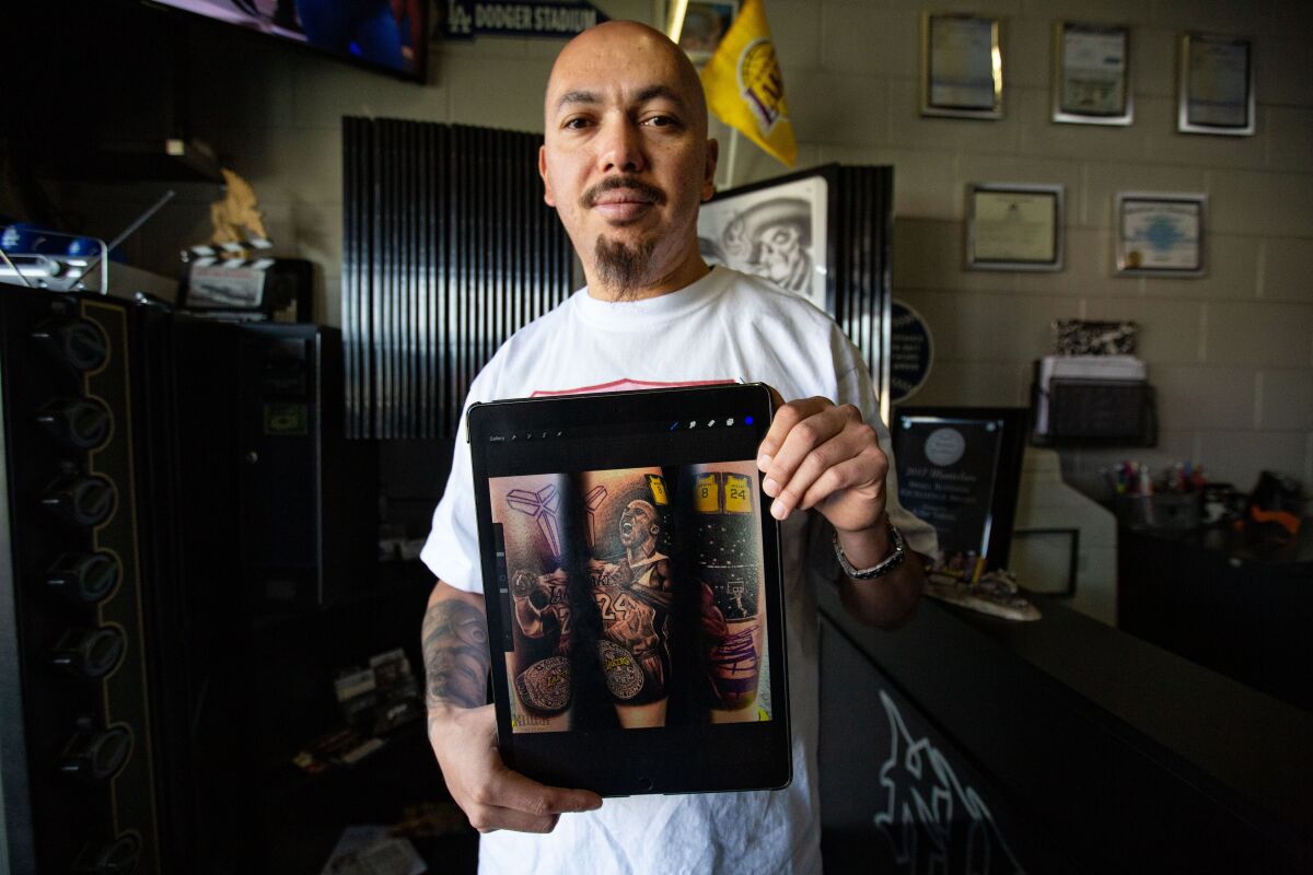 Jose Guijosa with photos of a Kobe Bryant-themed tattoo
