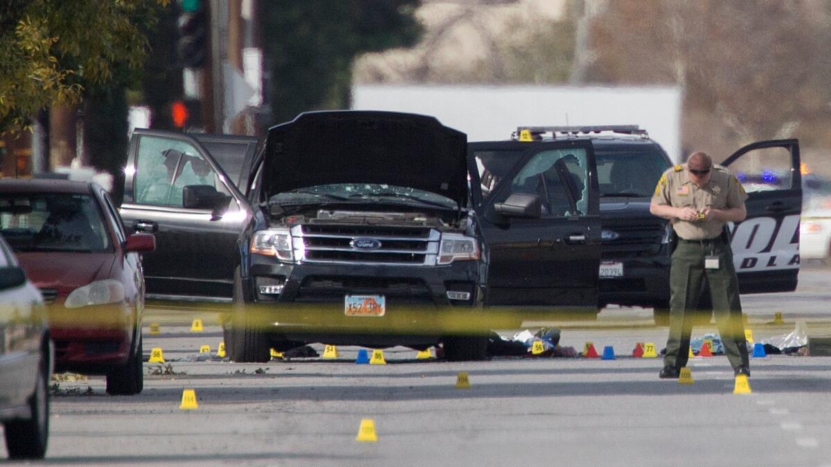 San Bernardino Sheriff Deputies investigate the scene where two suspects were gunned down following the Dec. 2, 2015 terror attack. (Gina Ferazzi / Los Angeles Times)