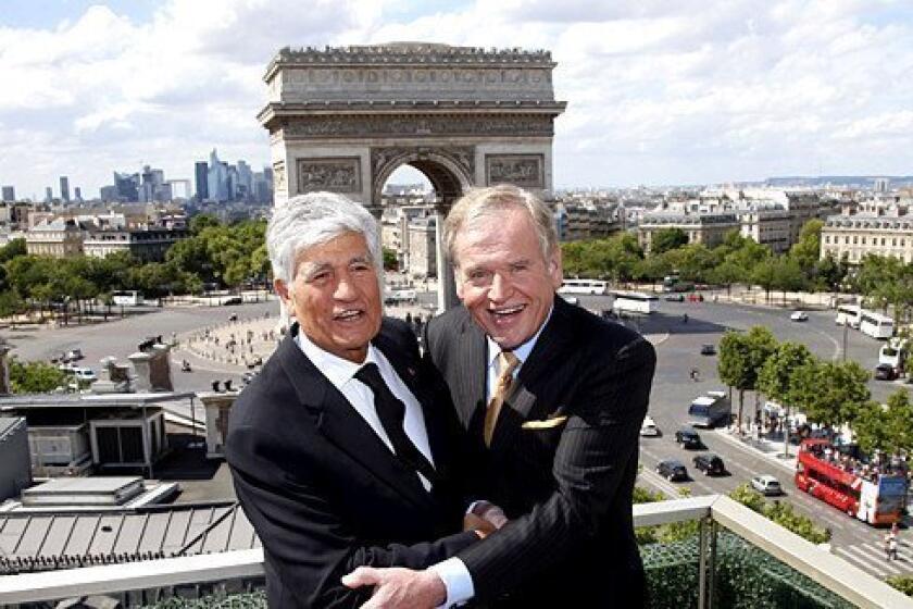 Maurice Levy, left, chief executive of French advertising group Publicis, and John Wren, head of Omnicom Group, pose during a joint news conference in Paris over the weekend. Publicis and Omnicom have announced merger plans to create the world's biggest advertising group.
