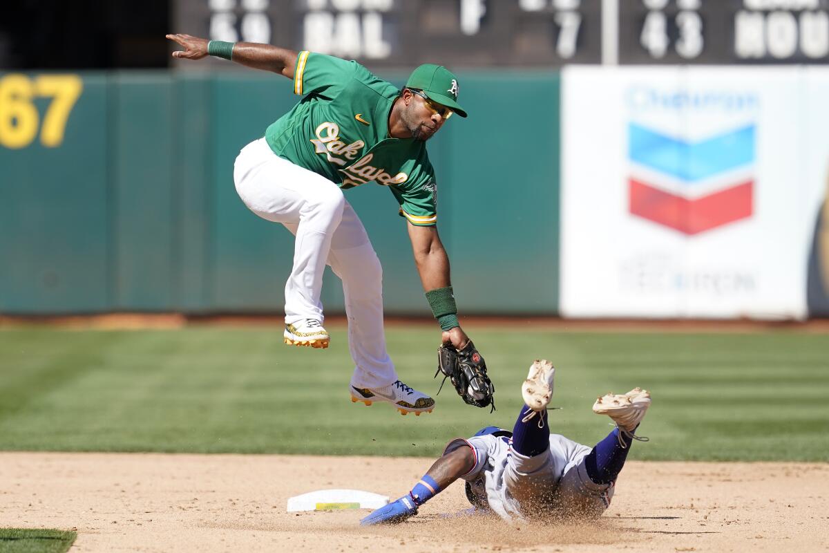 Texas Rangers' Yonny Hernandez, right, steals second base against Oakland Athletics shortstop Elvis Andrus during the sixth inning of a baseball game in Oakland, Calif., Sunday, Sept. 12, 2021. (AP Photo/Jeff Chiu)
